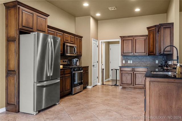 kitchen featuring stainless steel appliances, tasteful backsplash, and sink