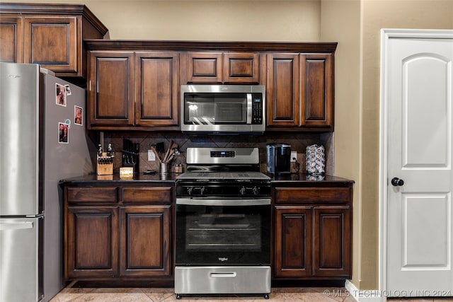 kitchen featuring dark brown cabinets, stainless steel appliances, and decorative backsplash