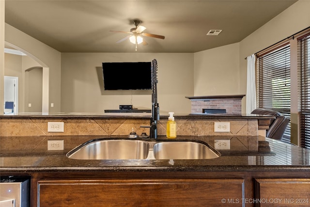 kitchen featuring sink, backsplash, and ceiling fan