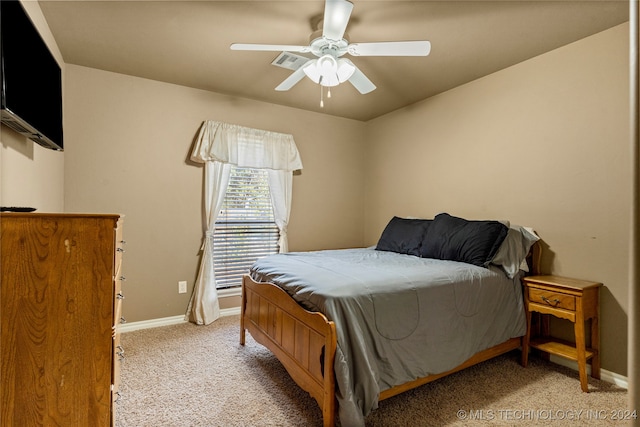 bedroom with ceiling fan and light carpet