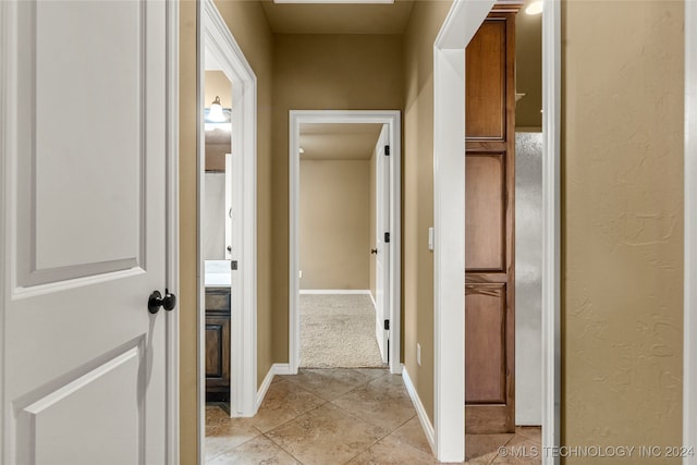 hall with light tile patterned floors