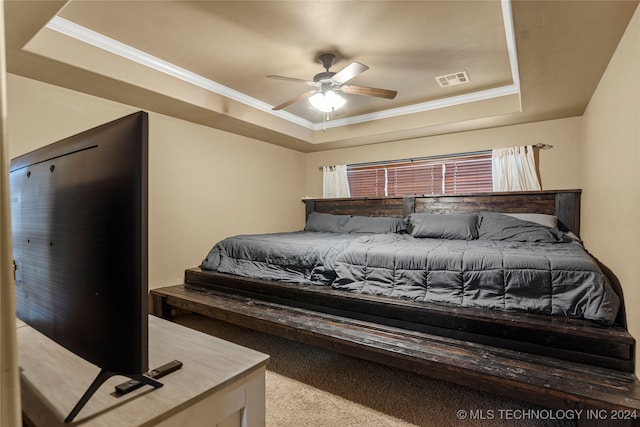 bedroom with light carpet, ornamental molding, a tray ceiling, and ceiling fan