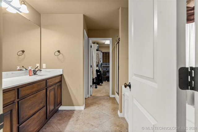 bathroom with vanity, tile patterned floors, and a shower