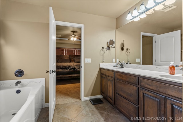 bathroom featuring vanity, ceiling fan, a bathtub, and tile patterned flooring