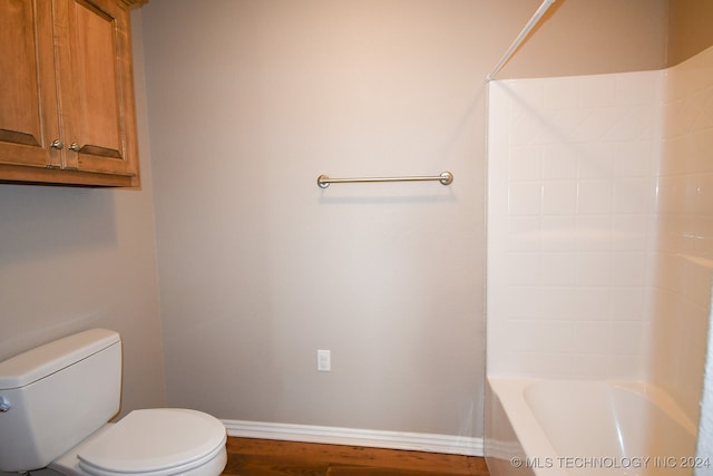 bathroom featuring bathing tub / shower combination and toilet