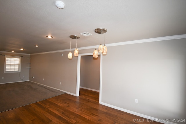 empty room with crown molding and dark hardwood / wood-style floors