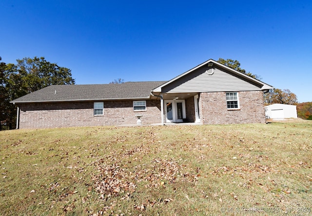 back of property featuring a yard