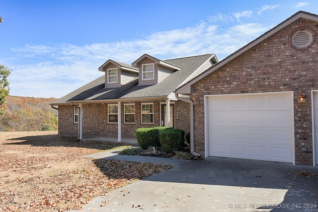 view of front of house with covered porch and a garage