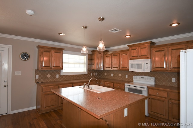 kitchen with a center island with sink, crown molding, white appliances, and sink