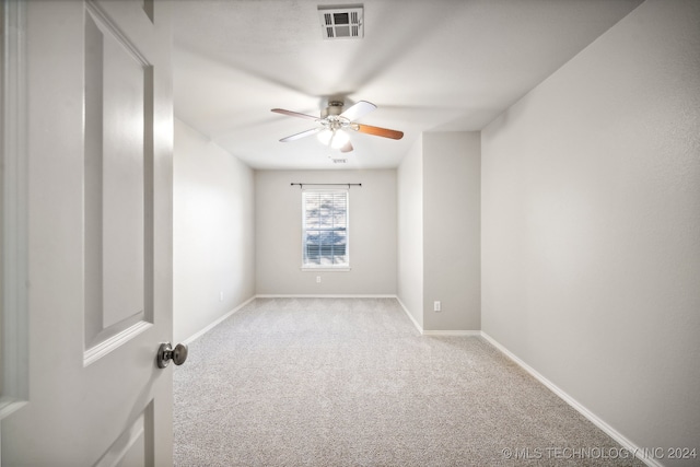 carpeted spare room with ceiling fan