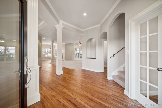 entrance foyer featuring ornate columns, wood-type flooring, and ceiling fan