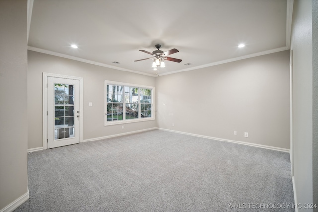 carpeted empty room featuring crown molding and ceiling fan