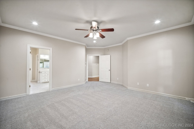 unfurnished bedroom featuring ornamental molding, ensuite bathroom, and ceiling fan