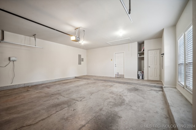 garage featuring a garage door opener and electric panel