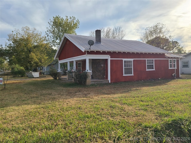 rear view of house with a lawn