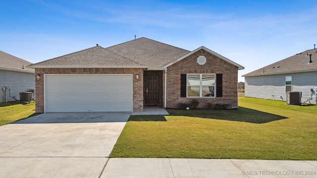 view of front of house with a front yard, central AC, and a garage