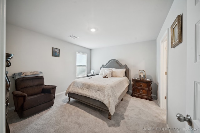 bedroom with light colored carpet