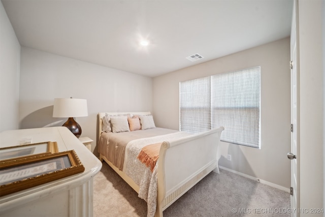 bedroom featuring light carpet