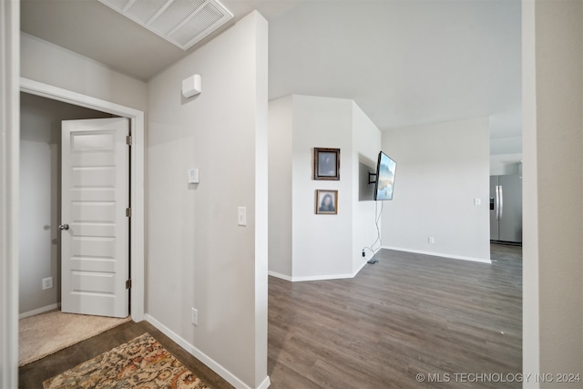 corridor with dark hardwood / wood-style flooring