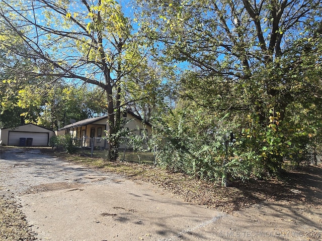 view of front of home with a garage and an outdoor structure