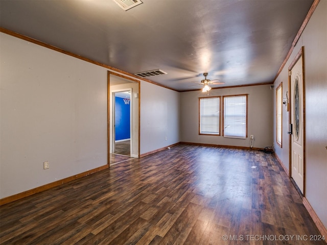 empty room with ceiling fan, crown molding, and dark wood-type flooring