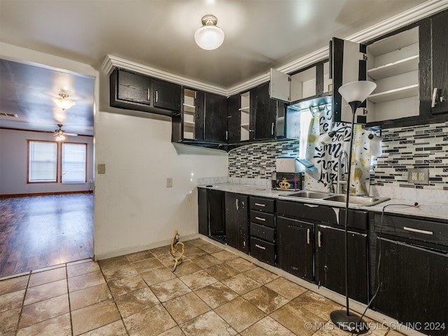 kitchen featuring sink, decorative backsplash, ceiling fan, ornamental molding, and light hardwood / wood-style floors