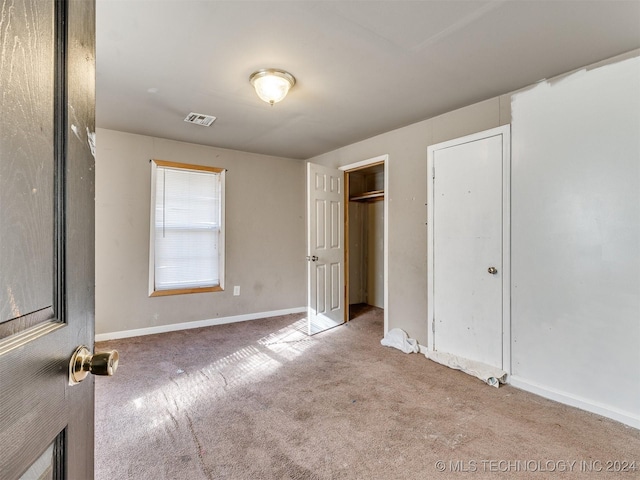 unfurnished bedroom featuring light colored carpet