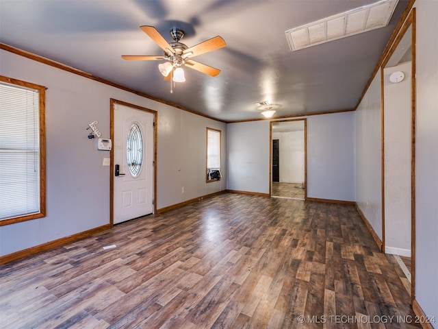 foyer entrance featuring ceiling fan, crown molding, and dark wood-type flooring