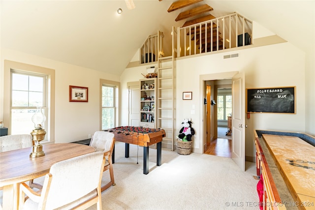 game room featuring a healthy amount of sunlight, light carpet, and high vaulted ceiling