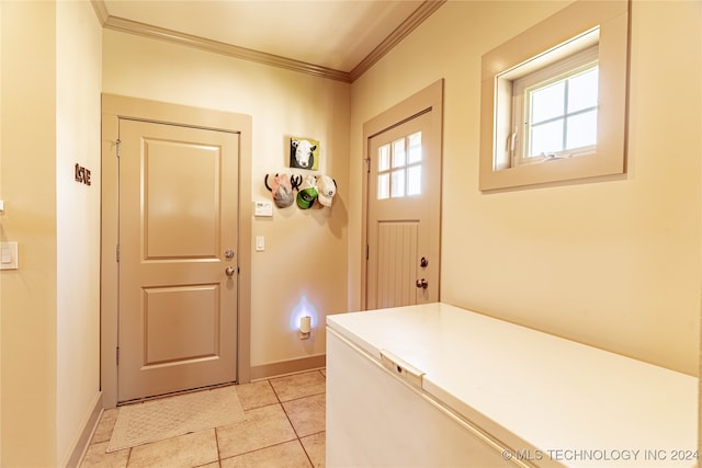 doorway to outside featuring ornamental molding and light tile patterned floors