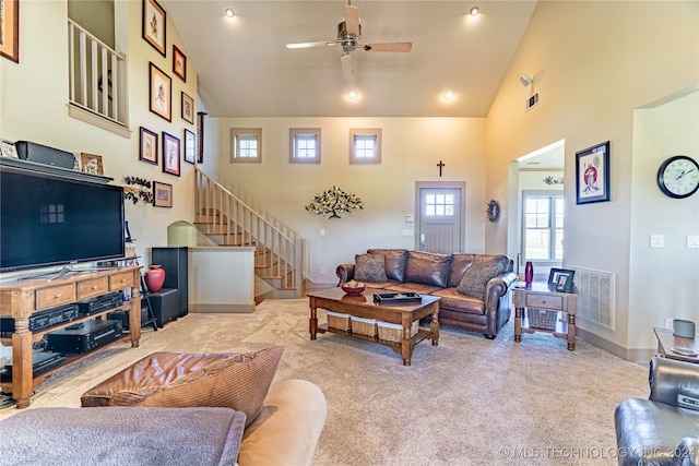 carpeted living room featuring high vaulted ceiling and ceiling fan