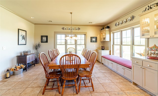 dining space featuring a notable chandelier, ornamental molding, and light tile patterned flooring