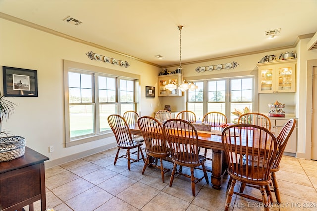 dining space featuring crown molding, a notable chandelier, and light tile patterned floors