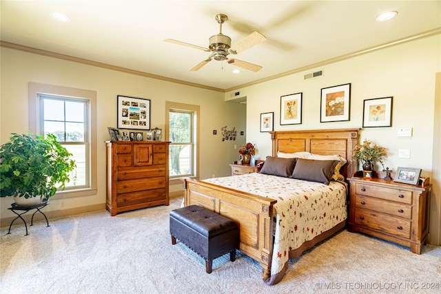 carpeted bedroom featuring ornamental molding and ceiling fan