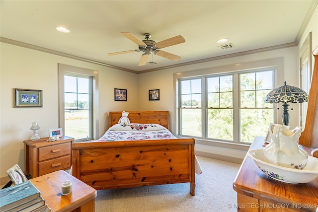 carpeted bedroom with crown molding and ceiling fan