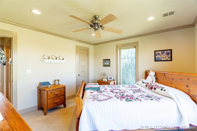 carpeted bedroom featuring ceiling fan and crown molding