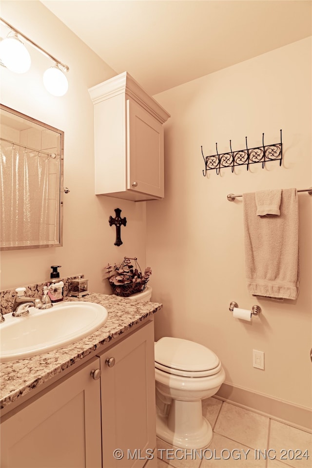 bathroom featuring vanity, toilet, and tile patterned flooring