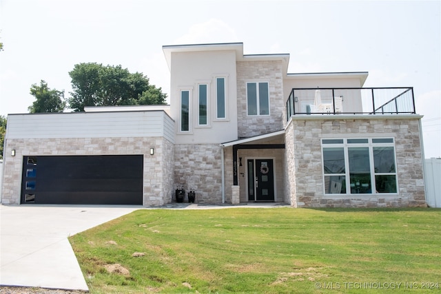 contemporary home featuring a front lawn, a garage, and a balcony