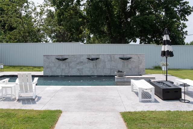 view of patio with an outdoor fire pit