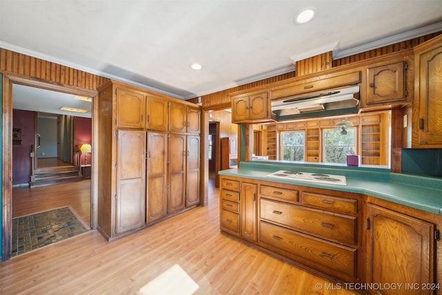 kitchen with light hardwood / wood-style flooring, white gas stovetop, exhaust hood, and crown molding