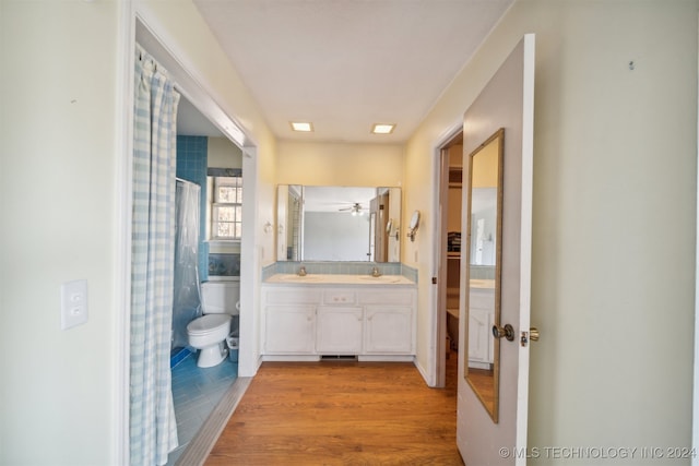 bathroom with vanity, hardwood / wood-style flooring, toilet, and a shower with curtain