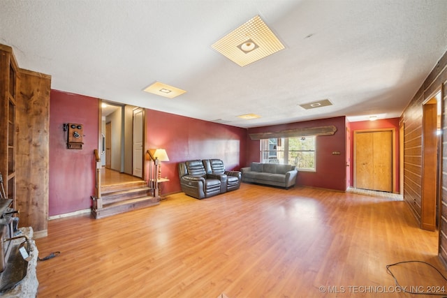 unfurnished living room with hardwood / wood-style flooring and a textured ceiling