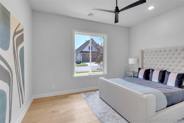 bedroom with ceiling fan and light hardwood / wood-style floors