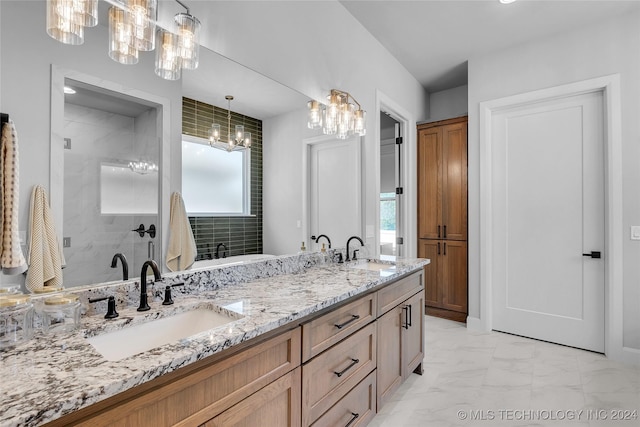 bathroom with tiled shower and vanity