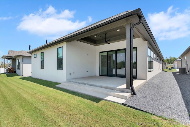 rear view of house with a lawn, ceiling fan, a patio, and central AC