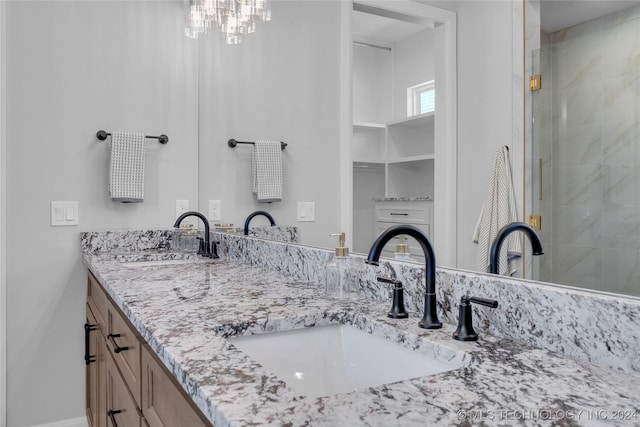 bathroom featuring vanity and a shower with door