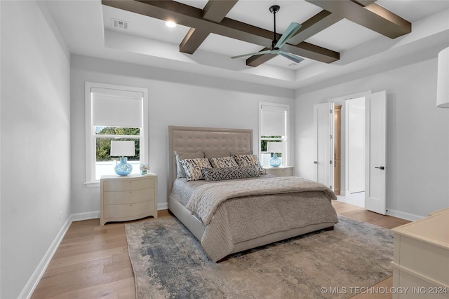 bedroom with beam ceiling, ceiling fan, light hardwood / wood-style flooring, and coffered ceiling