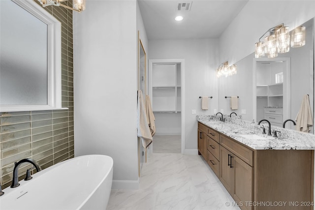 bathroom featuring vanity, tasteful backsplash, and a tub