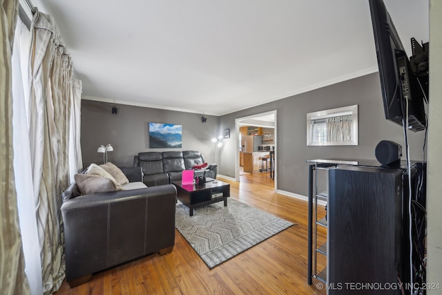 living room with hardwood / wood-style flooring and ornamental molding