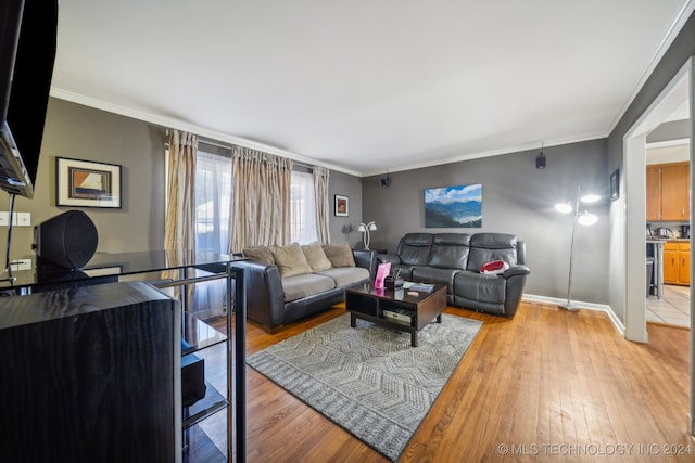 living room featuring light hardwood / wood-style flooring and crown molding